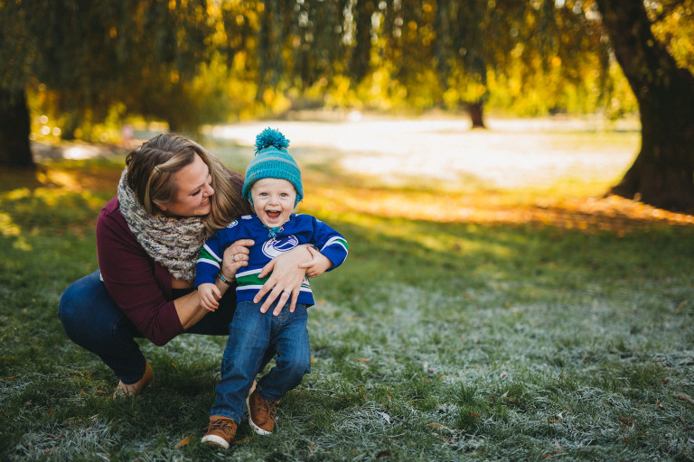 mom and son having fun playing in the leaves at a fall family photoshoot with Roxana Albusel photography