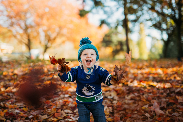 mom and son having fun playing in the leaves at a fall family photoshoot with Roxana Albusel photography